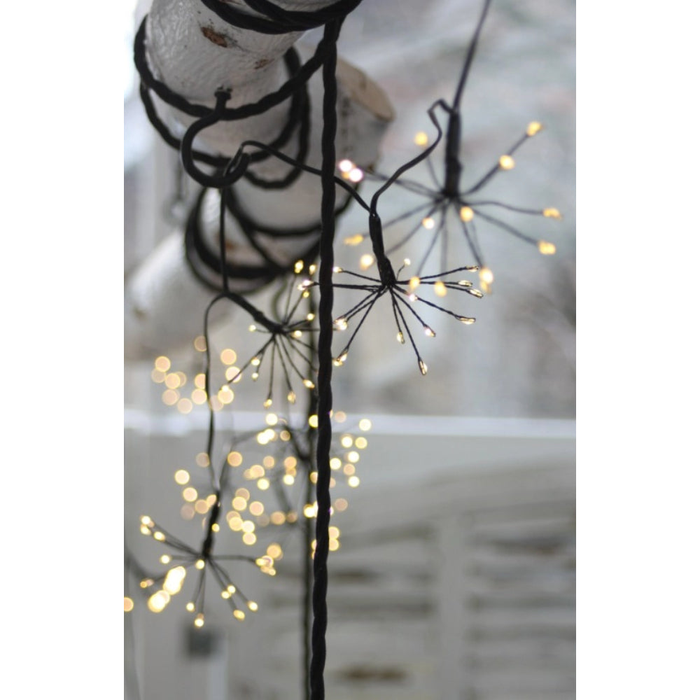 Decorative twig with string lights against a blurred background